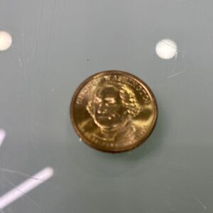 One dollar Gold tone George Washington dollar coin in mint condition